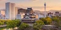 Skyline in Hiroshima with an ancient castle mixed with modern buildings.