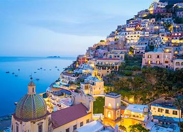 Colorful Coastal homes lit up at twilight in Positano
