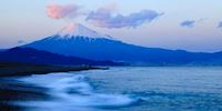 Snow-capped Mt Fuji towers over the coastline