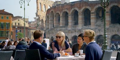 Group of people sitting at a table having coffee in Rome, Italy.